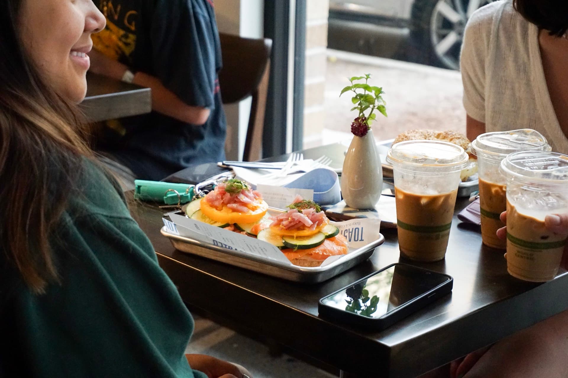 Friends enjoying bagels at TOASTED.