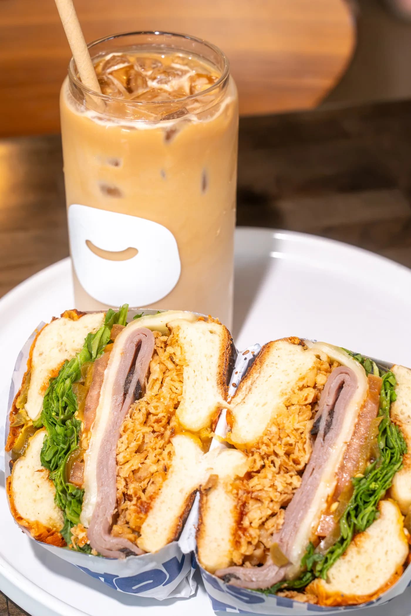TOASTED bagel sandwich and iced coffee
