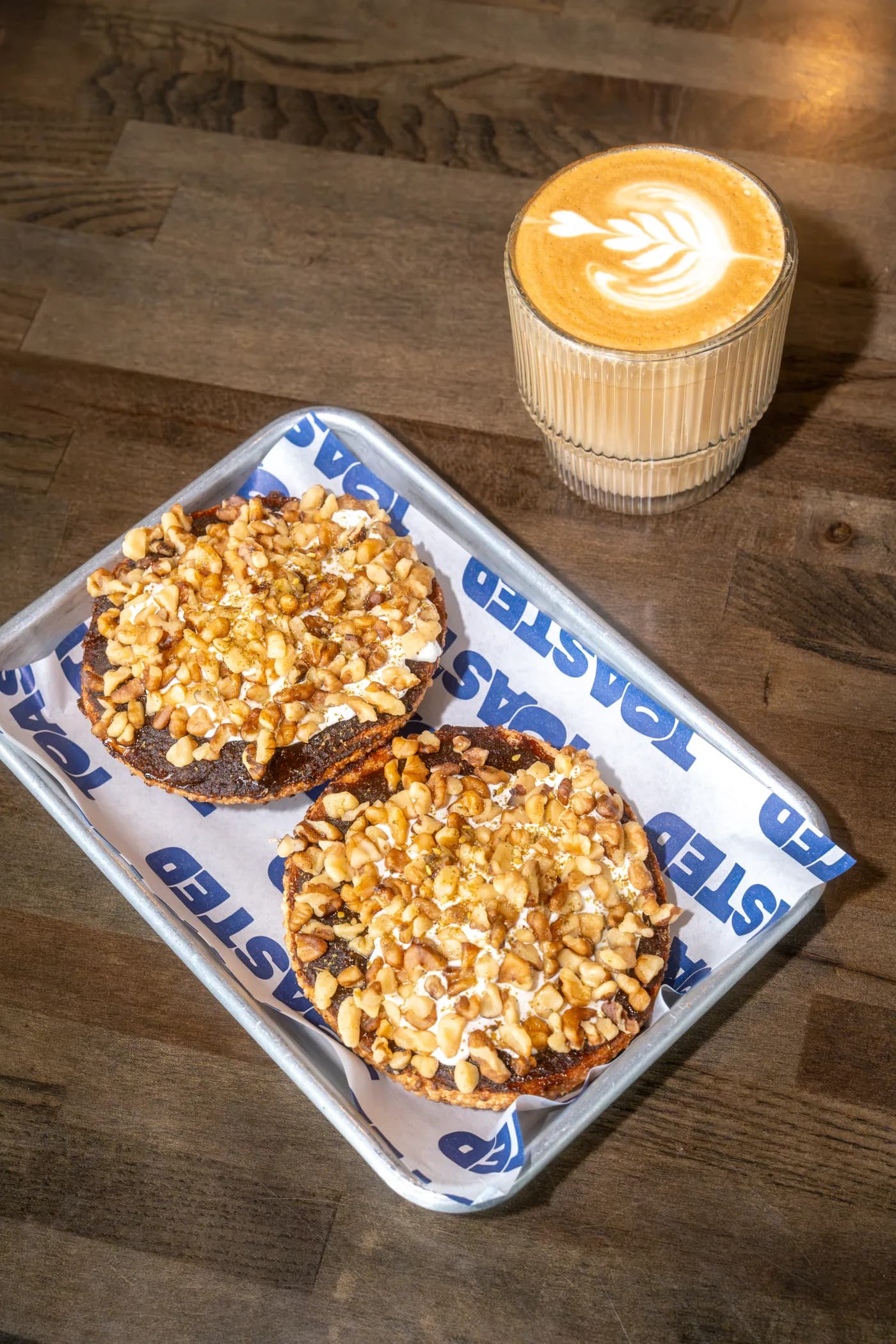 Date and labneh bagel with walnuts and a latte